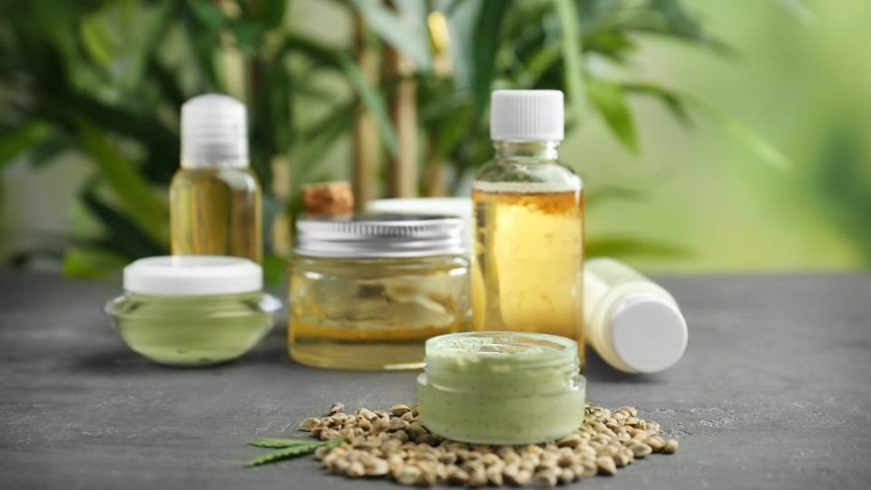 Hemp Cosmetic Products and Seeds on Grey Background
